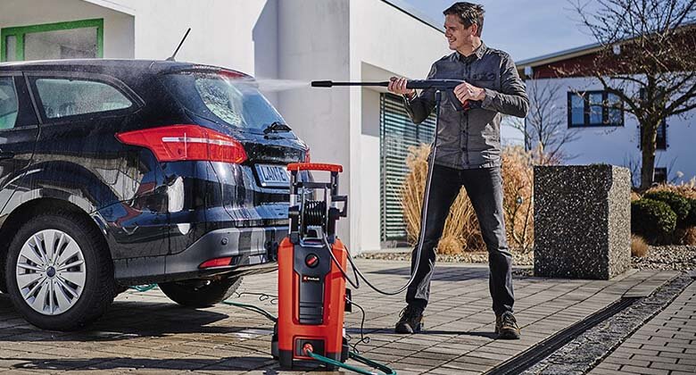 Man cleaning car with high pressure cleaner